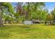 Beautiful front yard featuring a classic tree swing, mature trees and lush green grass at 4522 W North B St, Tampa, FL 33609
