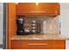 Gourmet kitchen area features sleek wooden cabinets, granite countertops, and a convenient coffee station at 4522 W North B St, Tampa, FL 33609