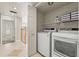 Convenient laundry room with modern washer and dryer, overhead shelving and easy access to the second floor at 4522 W North B St, Tampa, FL 33609