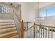Bright staircase featuring wood and white railings, with an open view of the modern living space below at 4522 W North B St, Tampa, FL 33609