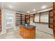 Luxury walk-in closet with wooden organizers, shelving, and granite island that offers lots of storage space at 4522 W North B St, Tampa, FL 33609