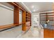 Custom designed walk-in closet with drawers, shelving and rod spaces, and an island with a granite countertop at 4522 W North B St, Tampa, FL 33609