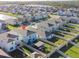 Aerial view showcasing the property with a patio and gazebo surrounded by beautiful landscaping and a lake nearby at 5571 Birch River Trl, Wesley Chapel, FL 33545