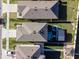 Aerial view showcasing the property's well-maintained lawn, outdoor kitchen, and proximity to neighboring homes at 5571 Birch River Trl, Wesley Chapel, FL 33545