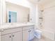Bright bathroom features a double vanity, toilet, and shower/tub with a white tile surround at 5571 Birch River Trl, Wesley Chapel, FL 33545