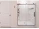 Modern bathroom features a sleek, glass-enclosed shower with built-in shelving and contemporary fixtures at 5571 Birch River Trl, Wesley Chapel, FL 33545
