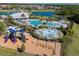 Resort-style community boasts pools, splashpad, playground and lake views, perfect for Gathering fun and relaxation at 5571 Birch River Trl, Wesley Chapel, FL 33545
