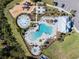 Aerial view of community amenities, including multiple pools, a splash pad, playground, and lounging areas at 5571 Birch River Trl, Wesley Chapel, FL 33545