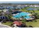 Aerial view of neighborhood with a large pool, cabana, and surrounding homes, perfect for community gatherings at 5571 Birch River Trl, Wesley Chapel, FL 33545