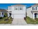 Two-story home featuring a two-car garage, neutral paint, and well-maintained landscaping at 5571 Birch River Trl, Wesley Chapel, FL 33545