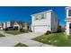 Two-story home featuring a two-car garage, neutral paint, and well-maintained landscaping at 5571 Birch River Trl, Wesley Chapel, FL 33545
