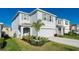 Two-story home featuring a two-car garage, neutral paint, and beautiful curb appeal at 5571 Birch River Trl, Wesley Chapel, FL 33545