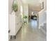 Inviting foyer with tile floors, a shoe cabinet, and views into the living spaces at 5571 Birch River Trl, Wesley Chapel, FL 33545