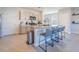 Modern kitchen featuring a large island with seating, stainless steel appliances, and white cabinets at 5571 Birch River Trl, Wesley Chapel, FL 33545