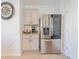 Kitchen with stainless steel refrigerator, adjacent to the breakfast bar and a coffee bar at 5571 Birch River Trl, Wesley Chapel, FL 33545