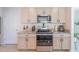 A bright kitchen features stainless steel appliances and ample counter and cabinet space at 5571 Birch River Trl, Wesley Chapel, FL 33545
