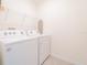Bright laundry room equipped with a washer and dryer, offering convenience and efficiency at 5571 Birch River Trl, Wesley Chapel, FL 33545