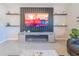 A living room featuring a modern entertainment center and built-in electric fireplace at 5571 Birch River Trl, Wesley Chapel, FL 33545