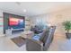 Comfortable living room with gray leather recliners, a modern entertainment center and decor at 5571 Birch River Trl, Wesley Chapel, FL 33545