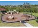 Neighborhood playground with slides, swings, and a merry-go-round, perfect for outdoor activities at 5571 Birch River Trl, Wesley Chapel, FL 33545