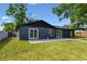 This backyard features a stone patio with sliding glass doors to the home at 5907 Tampa Shores Blvd, Tampa, FL 33615