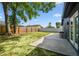 Fenced backyard with green grass and patio, great for outdoor living and entertaining at 5907 Tampa Shores Blvd, Tampa, FL 33615