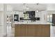 Modern kitchen with white cabinets, black backsplash, and a large center island with a marble countertop at 5907 Tampa Shores Blvd, Tampa, FL 33615