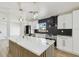 Bright kitchen with an island, modern light fixtures, and stainless steel appliances at 5907 Tampa Shores Blvd, Tampa, FL 33615