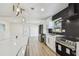 Bright and modern kitchen features white cabinets, stainless appliances, and island with quartz countertop at 5907 Tampa Shores Blvd, Tampa, FL 33615