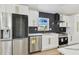 Updated kitchen featuring stainless appliances, quartz countertops, and gold hardware at 5907 Tampa Shores Blvd, Tampa, FL 33615