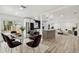 Open concept living and dining area with modern furniture and a stylish kitchen in the background at 5907 Tampa Shores Blvd, Tampa, FL 33615