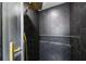 This is a detailed view of the luxurious tile shower with black hexagon tiles and gold hardware at 5907 Tampa Shores Blvd, Tampa, FL 33615