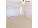 Carpeted bedroom with a glimpse into an adjoining room and multiple closets at 5925 Shore S Blvd # 608, Gulfport, FL 33707
