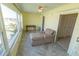 Bright bedroom featuring large windows with water view, a chaise lounge, desk area, and easy access to adjacent spaces at 5925 Shore S Blvd # 608, Gulfport, FL 33707