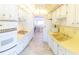 Well-appointed kitchen features white appliances, light countertops, and ample cabinet space, with easy access to the living room at 5925 Shore S Blvd # 608, Gulfport, FL 33707