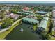 An aerial view highlighting buildings, a pool, and a tranquil pond with a fountain at 6123 113Th St # 510, Seminole, FL 33772