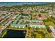 Aerial view of community with pond, gazebo, community pool, landscaping and nearby neighborhood at 6123 113Th St # 510, Seminole, FL 33772