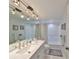 Bathroom featuring a wide mirror, track lighting, and shower with patterned curtain at 6123 113Th St # 510, Seminole, FL 33772