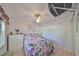 Cozy bedroom featuring a ceiling fan, floral bedding, and white dresser at 6123 113Th St # 510, Seminole, FL 33772