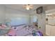 Bedroom with mirrored closet doors, ceiling fan, and access to kitchen at 6123 113Th St # 510, Seminole, FL 33772