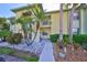 Charming two-story condo building with well-maintained landscaping, including palm trees and decorative stones at 6123 113Th St # 510, Seminole, FL 33772