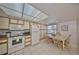 Well-lit kitchen and dining area featuring tiled floors, white appliances, ample cabinet space, and a window at 6123 113Th St # 510, Seminole, FL 33772