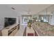 Bright living room with tile floors, balcony access, and mirrored wall feature at 6123 113Th St # 510, Seminole, FL 33772