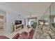 Spacious living room with a TV, comfortable furniture, and access to a balcony or patio area at 6123 113Th St # 510, Seminole, FL 33772