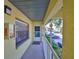 Exterior porch featuring unit 510's front door, window, and a view of the parking area at 6123 113Th St # 510, Seminole, FL 33772