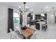 Elegant dining room featuring a modern chandelier adjacent to the kitchen with stainless steel appliances at 6132 Wire Grass Ct, Nokomis, FL 34275