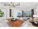 Bright living room with modern decor, dining area, and access to the outdoor patio at 6132 Wire Grass Ct, Nokomis, FL 34275