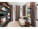 Inviting office space with built-in shelves, neutral tones, and abundant natural light from the window at 6132 Wire Grass Ct, Nokomis, FL 34275