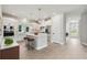 Bright, open kitchen boasts an island with seating and modern stainless steel appliances at 671 Allora Ave, Nokomis, FL 34275