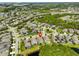 An aerial view of a community highlighting the neighborhood's layout, landscaping, and proximity to green spaces at 6907 Crestpoint Dr, Apollo Beach, FL 33572